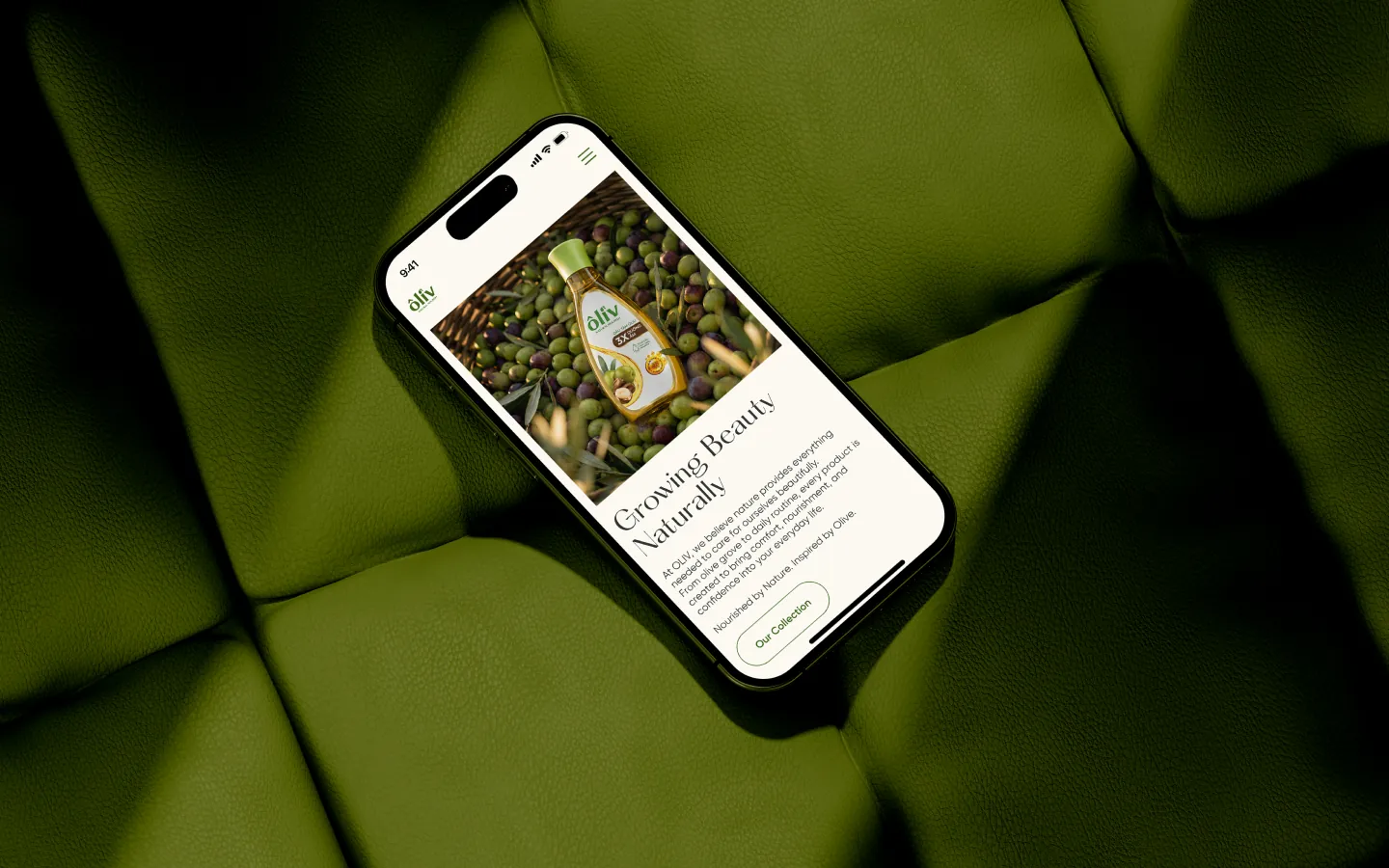 Oliv homepage on a smartphone resting on green leather